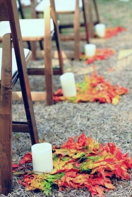 bright fall leaf arrangements and pillar candles are great to line up a fall wedding aisle instead of blooms