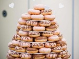 a minimalist round stand with glazed donuts is a stylish and cute idea for a modern wedding