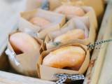 a box with glazed donuts in individual packs is a cool idea to serve them as wedding favors or just late night snacks