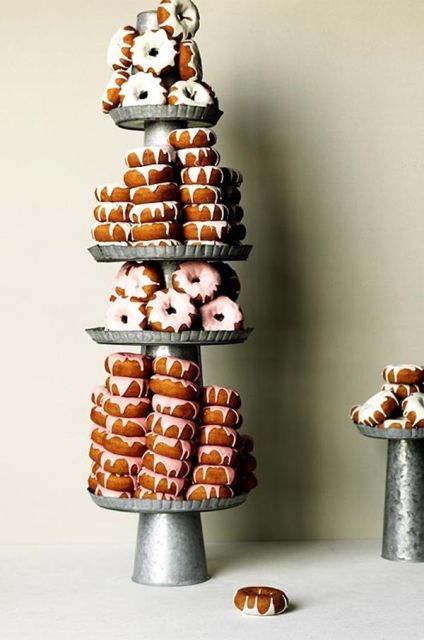 a super tall metal display for donuts and tons of them are ideal for a rustic wedding