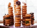 a board with a whole assortment of donuts on holders is a great alternative to a sweets table or a wedding cake