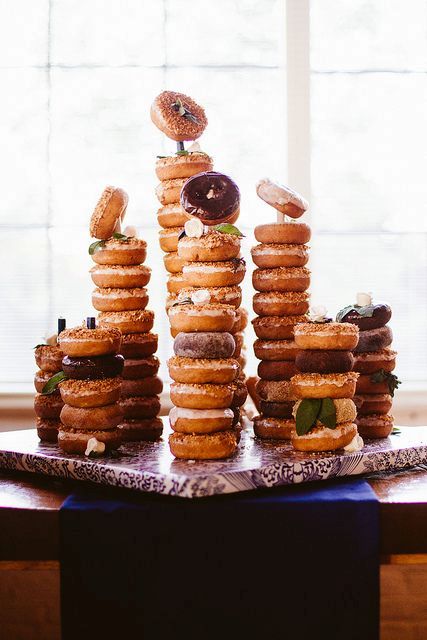 a board with a whole assortment of donuts on holders is a great alternative to a sweets table or a wedding cake