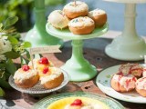 a sweets table with pastel vintage stands and glazed donuts of various kinds plus toppers