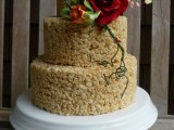 a krispie rice wedding cake decorated with sugar blooms and greenery is a sophisticated idea