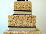 a square krispie rice wedding cake with ribbons and elegant silhouette cake toppers