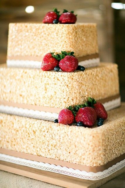 a krispie rice wedding cake with ribbons and lace ribbons plus fresh strawberries is a delicious idea