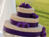 a krispie wedding cake with purple ribbons and blooms for a sophisticated wedding cake
