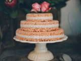 a mini krispie rice wedding cake with lace ribbons and pink roses on top is cute