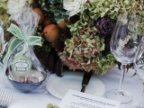 a beautiful fall wedding centerpiece of green and white blooms, artichokes and pears, and greenery is a lovely idea for a harvest wedding in the fall