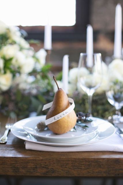 a pear wrapped with a name is a creative idea of a wedding seating card, and can double as a favor, great for a fall wedding