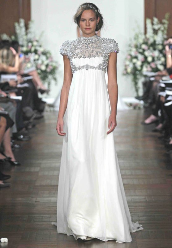 a statement empire waist wedding dress with a fully embellished bodice with cap sleeves and a pleated skirt