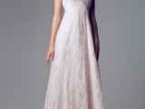 a classic blush lace A-line empire waist wedding dress with spaghetti straps and a pleated skirt plus statement earrings