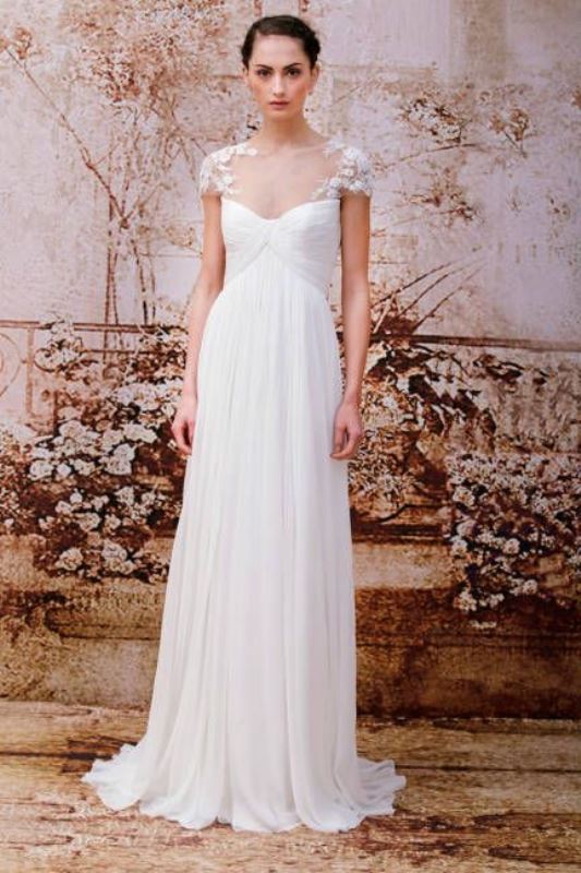 a romantic wedding dress with lace sleeves, a draped bodice, an empire waist and a pleated skirt