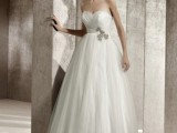 a strapless wedding ballgown with a draped bodice, an embellished sash and a full skirt
