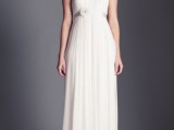 a vintage-inspired wedding dress with a lace illusion neckline, applique sleeves, a draped bodice and a pleated skirt