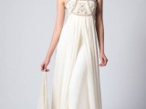 a strapless empire waist wedding dress with an embroidered and embellished bodice and a draped skirt with a train
