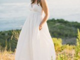 a minimalist empire waist wedding dress with spaghetti straps, a draped bodice and pleated skirt for a modern wedding