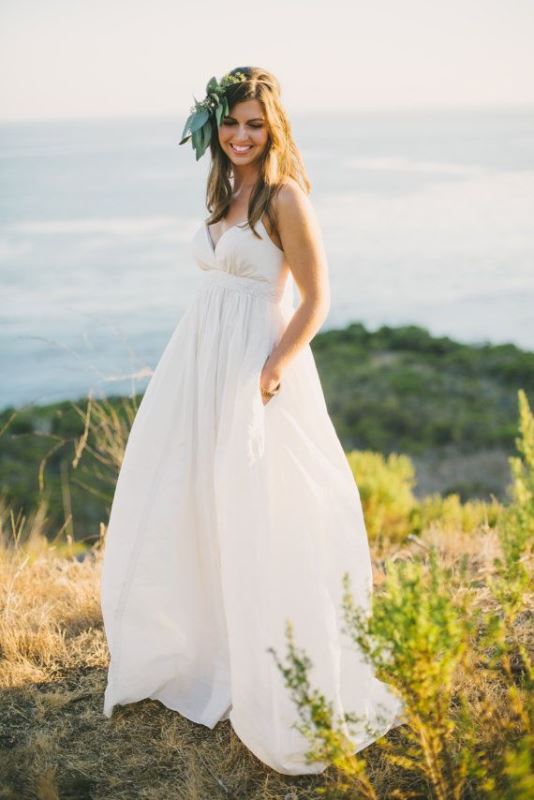 a minimalist empire waist wedding dress with spaghetti straps, a draped bodice and pleated skirt for a modern wedding