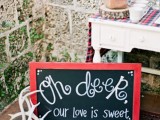 a chalkboard sign in a red frame plus some antlers for funny and whimsy Christmas or just winter wedding decor