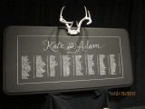 a chalkboard seating chart topped with antlers is a creative idea for a winter or woodland wedding