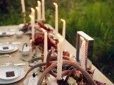 a flower and candle centerpiece paired with antlers looks much more interesting and catchy and feels more woodland-like