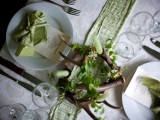 a spring woodland wedding table wiht a green runner, antlers as candleholders and green candles is wow