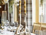 antlers as candleholders and striped candles to decorate a winter wedding table