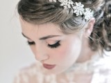 a beautiful low curled ponytail with a gorgeous embellished floral headpiece for a super refined and girlish bridal look