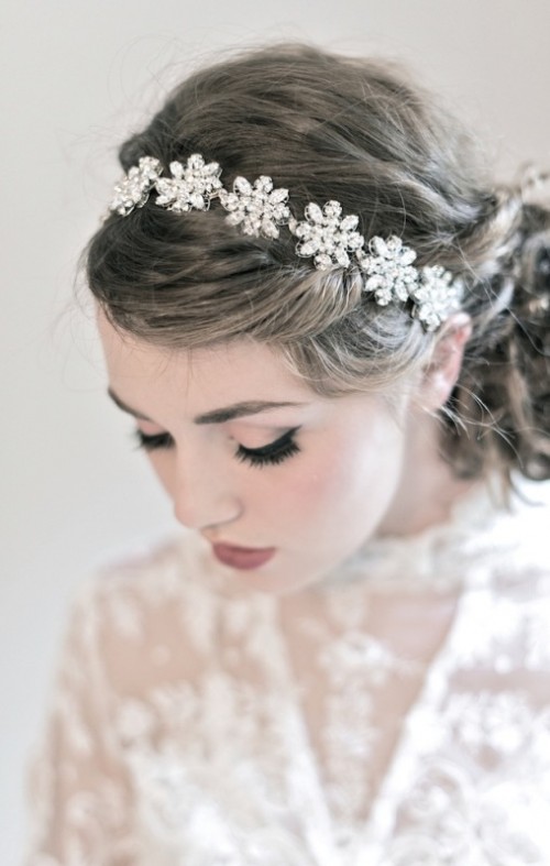 a beautiful low curled ponytail with a gorgeous embellished floral headpiece for a super refined and girlish bridal look