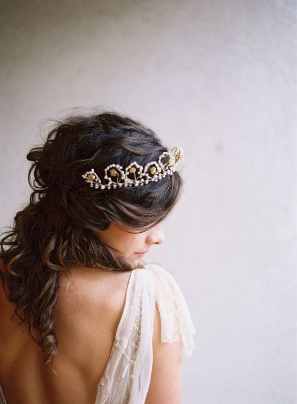 Loose wavy half updo accented with a beautiful pearl and gold rhinestone tiara for a refined and effortlessly chic look