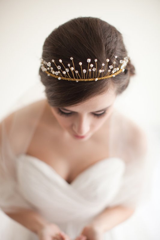 A low updo with an embellished wedding tiara are a perfect idea for a modern refined bridal look with a royal touch