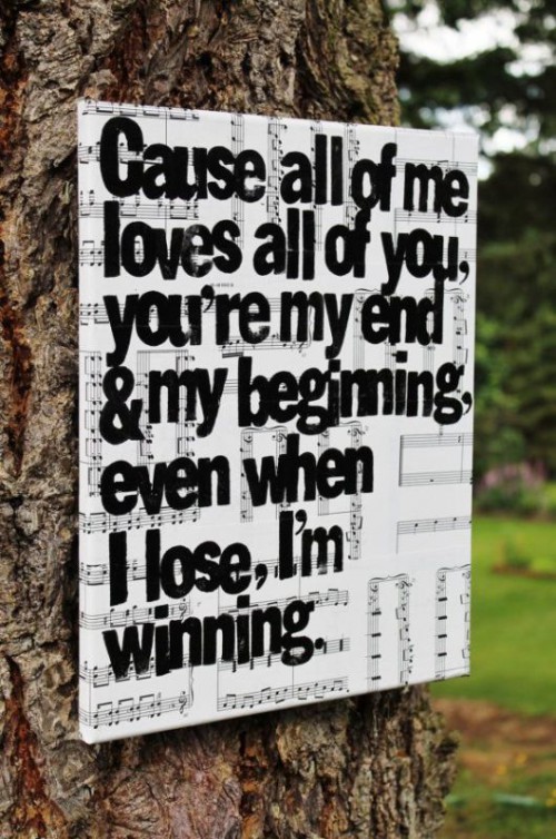 a lovely music paper sign with a quote from a song will give a lot of personality to your wedding decor