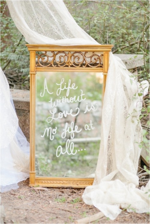 a vintage mirror in a chic frame with a white calligraphy quote is a stylish decoration for a vintage wedding and you can DIY it