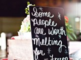 a black chalkboard quote instead of a table name or table number is a smart and cool solution for a wedding