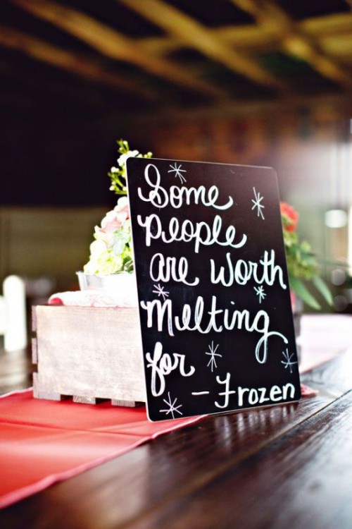 a black chalkboard quote instead of a table name or table number is a smart and cool solution for a wedding