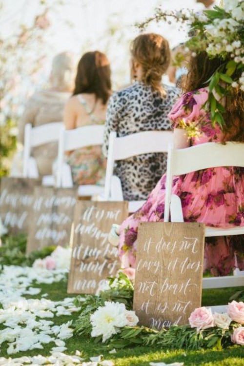 stained plaques with white calligraphy, white petals and blooms on the aisle are amazing to make it look cooler