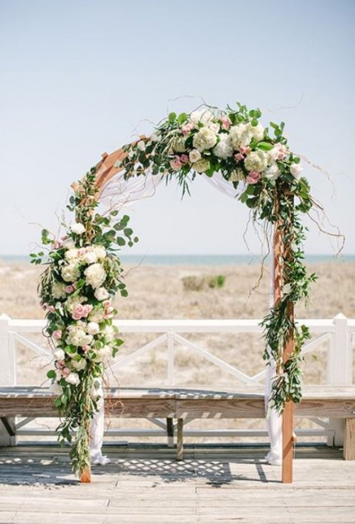 a lovely wedding arch with blush, white blooms, eucalyptus and twigs is a pretty and very romantic idea