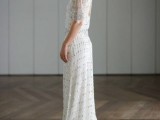 a 20s inspired fitting white fully embellished wedding dress with a keyhole back, short sleeves and a train