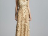 a gold embellished spaghetti strap wedding dress with a draped bodice and a fitting silhouette