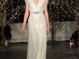 a sparkling fully embellished 20s inspired wedding dress with a depe neckline and an embellished sash