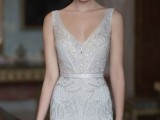 a glam fitting white and silver embellished wedding dress with no sleeves and a deep neckline