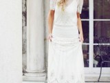 a Great Gatsby inspired fully embellished wedding dress with an illusion neckline, short sleeves and vintage-inspired shoes