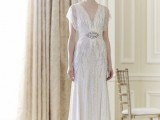 a white 1920s inspired wedding dress with silver embellishments, cap sleeves and an embellished sash