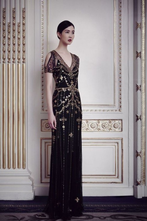 a statement fititng black gold embellished wedding dress with a cold shoulder, a V-neckline