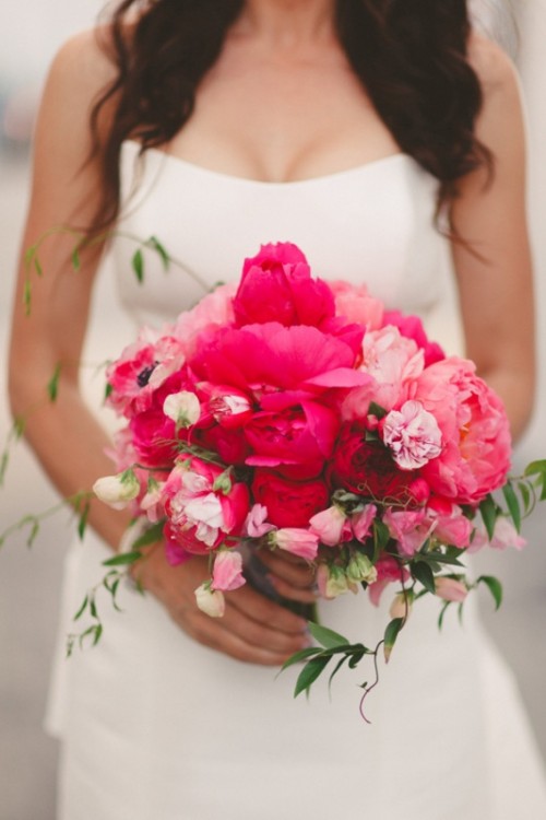 a bold hot pink and fuchsia wedding bouquet with peonies, small garden roses and greenery for a bright wedding