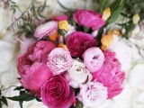 a pink and light pink wedding bouquet with peonies, ranunculus, yellow garden roses for a spring or summer wedding