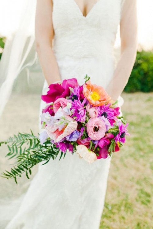 a hot pink and lilac wedding bouquet with blush and yellow blooms and some greenery is a fantastic idea for a tropical wedding