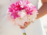 a neutral wedding bouquet with blush and bold pink blooms is a fantastic idea for a spring or summer wedding, it will fit a tropical celebration, too