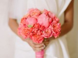 a coral and pink wedding bouquet is a bold and catchy idea for a spring or summer wedding