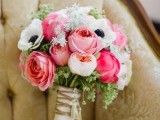 a pink wedding bouquet of roses, white anemones and some fillers for a spring or summer wedding